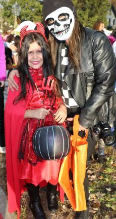 Lydia Rivera, 8, with her mom Lorice Angie, switched from last year's angel costume to one as a devil.