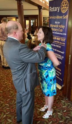 Warwick Valley Rotary Club President Tina Buck receives her presidential pin from outgoing president Ed Wiley during the club&#x2019;s 44th annual installation ceremony June 26 at the Chateau Hathorn.