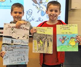 Students show off their hand-crafted graphic novels.