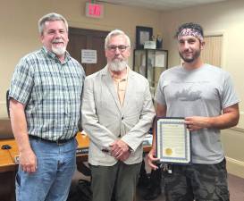 Warwick Mayor Michael Newhard presents an award proclamation to DPW tool designer Michael Finelli and DPW Supervisor Michael Moser during the July 11 Warwick Village Board meeting.