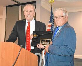 Warwick Town Justice Peter Barlet, left, accepts congratulations on being named New York Magistrate of the Year by last year’s recipient, Paul W. Peter, Schodack town justice in Rensselaer County.