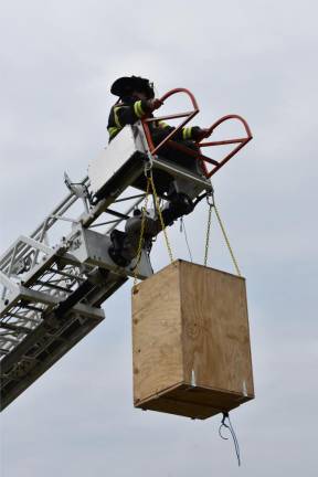 A box with about 2,000 numbered balls is hoisted on the Greenwood Lake Fire Department’s ladder truck.