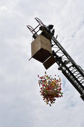 About 2,000 color balls are released above a target in Winstanley Park.