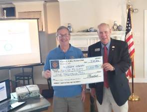 <b>Neil Sinclair, left, who completed his fourth term as Warwick Valley Rotary Club president on June 30, presents a $1,000 donation check to Bill Sestrom, a former Newburgh Rotary Club president and charter board member of the Hudson Valley Honor Flight. </b>
