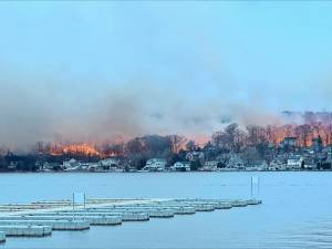 WMF0 Flames can be seen across Greenwood Lake about 5 p.m. Sunday, Nov. 10. The photo was taken near D’Boathaus on the west side of the lake. (Photo by Denise von Wilke)