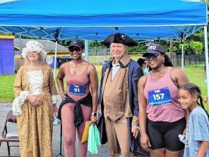 ”George and Martha Washington” pose with 5K runners.