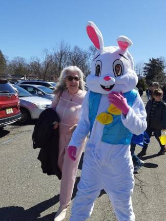 Caryl Romeo, director of religious education at Our Lady Queen of Peace Church in Hewitt, N.J., stands next to the Easter bunny Sunday, April 2.