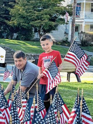 Florida Mayor Dan Harter Jr. also helped the scouts place the flags.