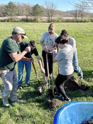 The volunteers worked hard to plant the trees in celebration of Earth Day.