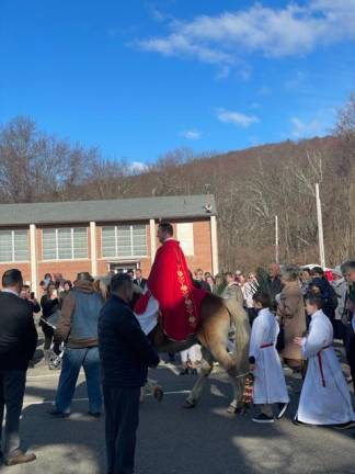 Father Kamil Stachowiak, priest at Our Lady Queen of Peace Church in Hewitt, N.J., arrives for Palm Sunday services on a Haflinger horse named Davy Crockett. (Photos provided)