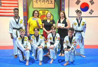 The Chosun Taekwondo Academy Leadership Team with Lion Trish Smyth, left, Director Kara Geh, center, and Lion Erin Andersen.