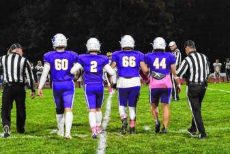 Warwick football captains Michael Miller (#60), Brody Frederick (#2), Michael Hennessy (#66), and Grant Havell (#44) approach for the coin toss ahead of their 34-15 win over the Panthers. Not pictured: captain Wyatt Vreeland (#41). Senior leadership has been the key to Warwick’s 7-0 start.