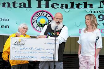 Warwick Cares - Second Annual Mental Health Month Celebration at Railroad Green on May 4. Wayne Patterson, president of “Team Up For Hope,” presents mental health and suicide prevention advocate of Warwick Cares Mental Health Initiatives Judy Battista with a check for $500.