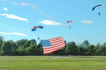 A skydiver from New York Tandem Sky Diving of Greenwood Lake Airport performed the “Flag Jump” while holding the American flag alongside another skydiver.