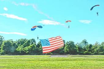 AIR1 A skydiver from New York Tandem Sky Diving performs the ‘Flag Jump’ while holding the American flag alongside another skydiver at the New Jersey Airshow in West Milford. (Photo by Ed Bailey)