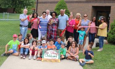 On Friday, Aug. 16, Town of Warwick Supervisor Michael Sweeton (left) and members of the Warwick Valley Chamber of Commerce joined Director Etta Hamilton (center), her husband, John, associates, friends, parents and children to celebrate the grand opening of the new preschool with a ribbon-cutting.