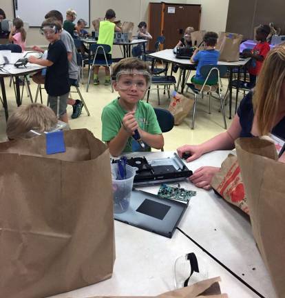 Among the projects undertaken by some of the campers was to take apart items such as computer hard drives to see how they worked so they could create their own inventions.