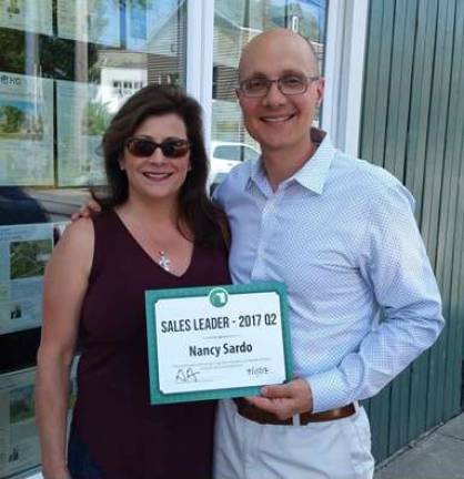 Provided photo Geoff Green presents Nancy Sardo with the Green Team Home Selling System's Second Quarter Sales Leader Award.