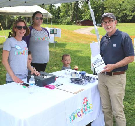 From left, Warwick Playground Dreams committee member Dana Tuckfelt, a mother of three girls, and Board Member Lisa Hroncich, a homeschooling mother with her two boys, welcome Town of Warwick Supervisor Michael Sweeton to Play for the Park.