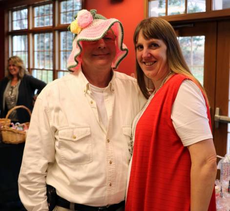 Shoppers Charlie Kittner and Wendy Leahy clown with a hat designed and crafted by vendor Amy Lawlor of Originals Made by Amy.