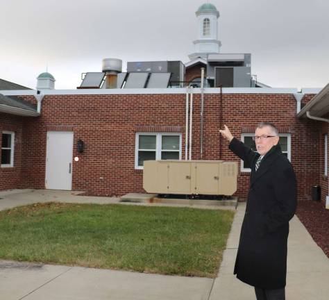 Photo by Roger Gavan Town of Warwick Supervisor Michael Sweeton points to some of the solar energy improvements at the Town Hall.