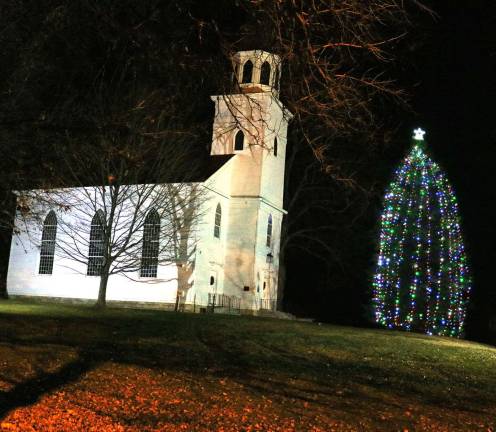 The Historical Society of the Town of Warwick has helped the Warwick Fire Department continue its long tradition by graciously providing the magnificent evergreen, just outside its Old School Baptist MeetingHouse.