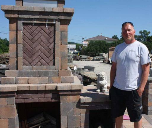 Route 23 Patio and Mason Center manager Sean with an assembled outdoor fireplace kit
