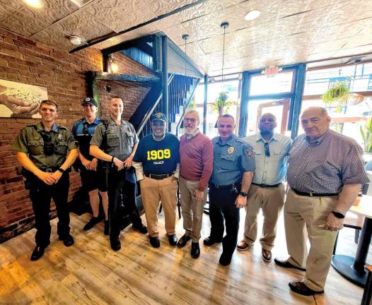 Gathering for a photo at the Coffee with a Cop event (from left) are Officer Ryan King, Officer Neil Ryan, Lt. Keith Slesinski, Manny Tirado, Mayor Michael Newhard, Chief John Rader, Luis Abramson, and Town Councilman Floyd DeAngelo.