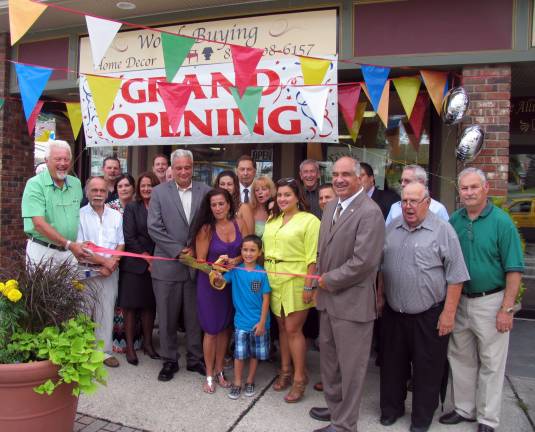 Photo by Roger Gavan On July 10, local elected officials and Board members of the Village of Florida Chambers of Commerce joined owner Andrea Muster and her family to celebrate the grand opening of Worth Buying Home D&#xc8;cor. Andrea Muster (center) pictured with her husband, John, son Michael, 9, and daughter Krysta, cuts the ribbon held by Florida Chamber of Commerce President Jan Janson (left) and Town of Warwick Deputy Supervisor James Gerstner (right).