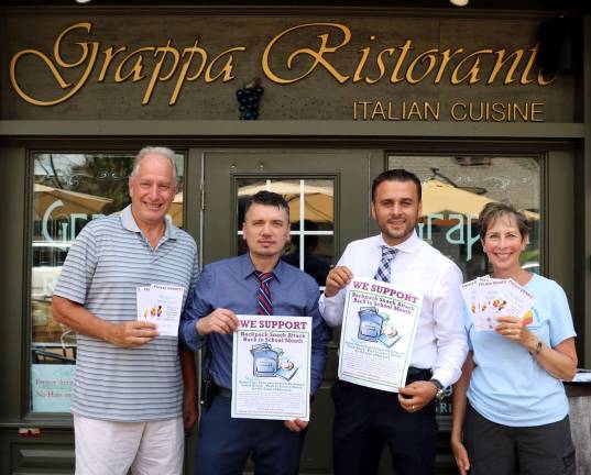 Photo by Roger Gavan Among Backpack Snack Attack's biggest supporters is the Grappa Ristorante on Railroad Avenue in the Village of Warwick. Picgured are: Backpack Snack Attack volunteers Len Singer (left) and Arlene Neiman deliver fund-raising materials to Grappa partners Nick Ahmetaj and Tony Sylaj.