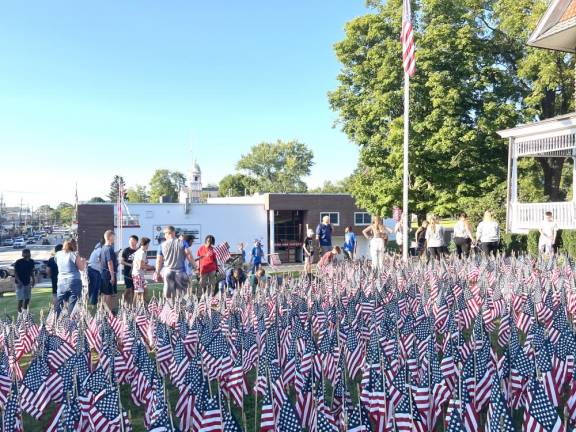 Scouts and volunteers came out to place the flags in front of Vllage Hall in Florida.