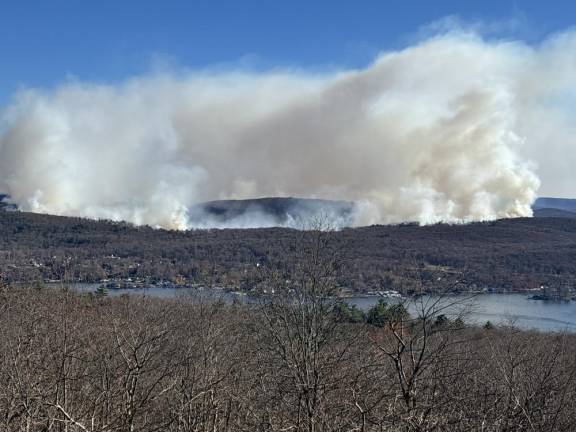 Smoke rises from wildfires on the eastern side of Greenwood Lake.