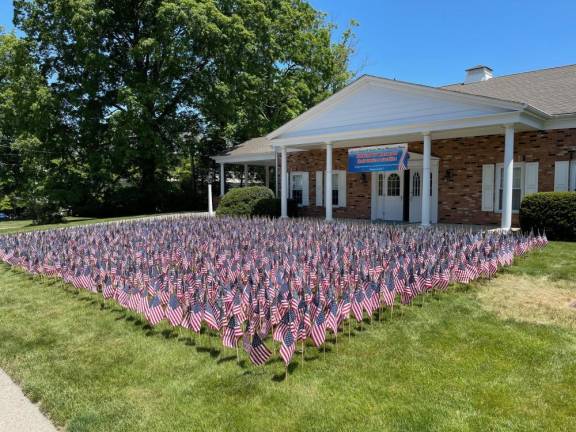 Every year at Memorial Day, the Lazear, Smith and VanderPlaat Memorial Home on Oakland Avenue in Warwick decorates its front lawn with flags in memory of veterans who have passed away from the town of Warwick, including Pine Island, Florida, and Greenwood Lake. This year the company placed 2003 flags. With the help of family and friends of the memorial home, the flags are carefully placed on the lawn.