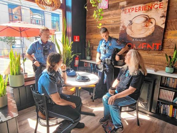 Warwick resident Colleen LoPinto (right) has a conversation with Town of Warwick Police Officers Jordan Tetreault, Kyle Smith, and Ryan King during the May 20 “Coffee with a Cop” event at Café e Dolci.