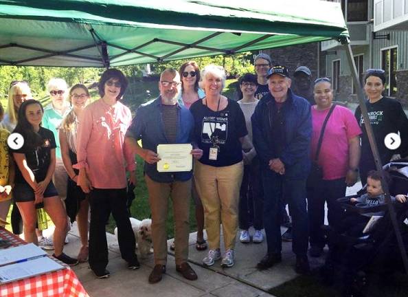 Provided photo Friends of the Library members Norman Isaacson and Mary Berrigan look on as Mayor Michael Newhard presents Library Director Rosemary Cooper with a certificate in honor of the 10th anniversary of the Albert Wisner Public Library's new facility at One McFarland Drive in the Village of Warwick.