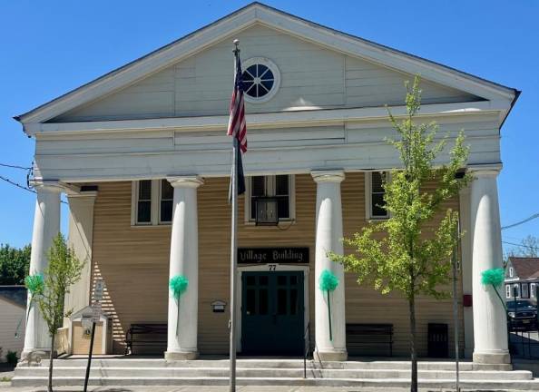 Green bows and ribbon hang from the pillars of the Warwick Village Hall on Main Street in honor of Mental Health Awareness Month.