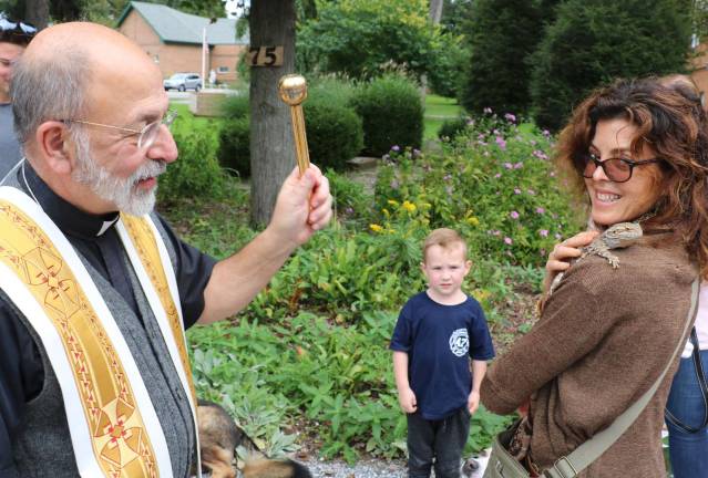 St. Stephen&#x2019;s pastor, the Rev. Jack Arlotta, blessed each animal, like &quot;Scamp,&quot; an Australian Bearded Dragon lizard owned by Maria Newsom, a visitor from Brooklyn.