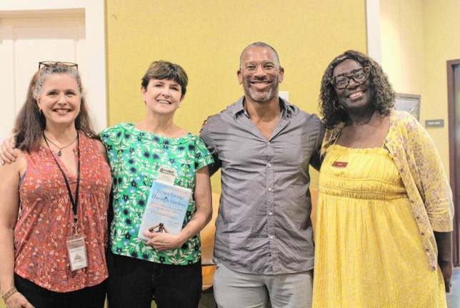 Christian Cooper stands with library staff.