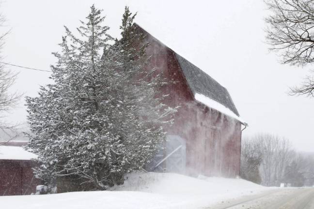 Winds blow snow off this barn along County Rt 1 in Warwick, NY, during Saturday morning’s snow storm.