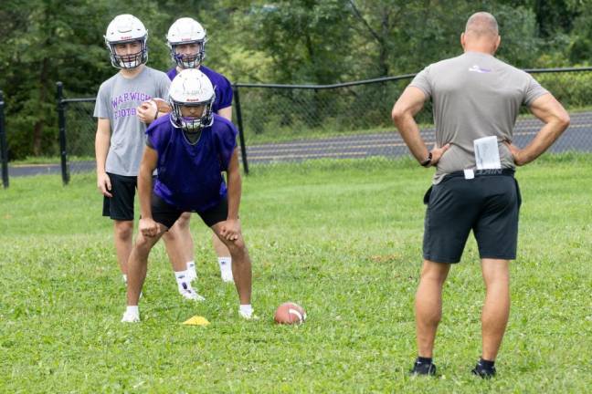 Players run through drills on the first day of football practice on Aug. 19, 2024.