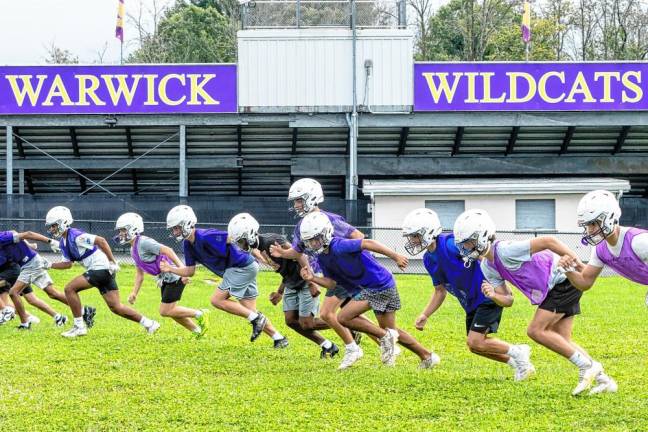 Players run through drills on the first day of football practice on Aug. 19, 2024.