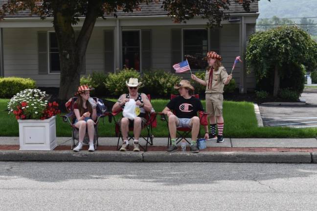 Residents line the sidewalks of Windermere Avenue to watch the parade.