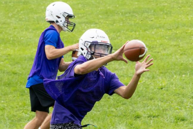 Players run through drills on the first day of football practice on Aug. 19, 2024.