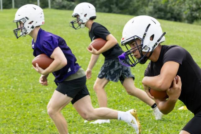 Players run through drills on the first day of football practice on Aug. 19, 2024.