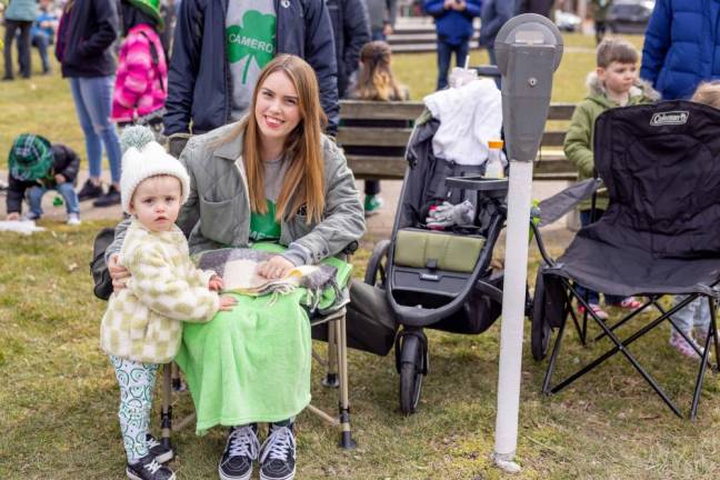 Elenor, 2, of Goshen and her mom Christine at the Mid-Hudson St. Patrick's Day Parade in Goshen, NY on March 12, 2023. Photo by Sammie Finch