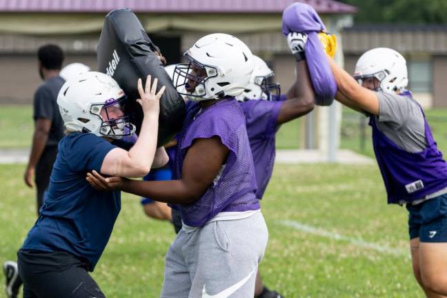 Players run through drills on the first day of football practice on Aug. 19, 2024.