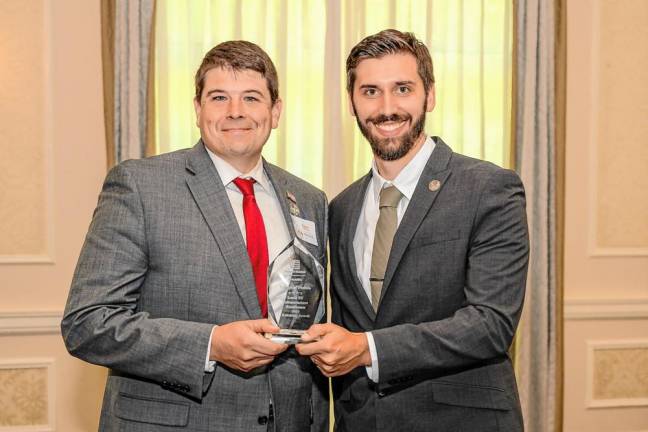 Florida Mayor Daniel Harter Jr. accepts an award from O&amp;R Director of E-Mobility Andrew Farrell at the company’s first annual “E-Mobility Awards” event on Sept. 19.