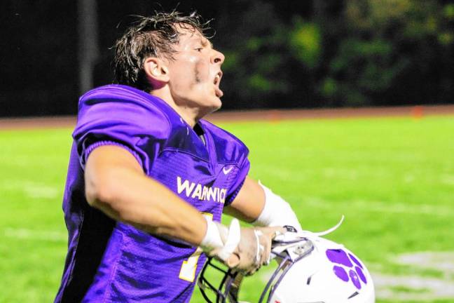 Senior linebacker Colton Senius, #7, celebrates a defensive stop for the Wildcats.