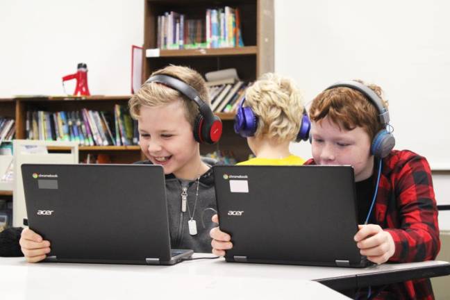 Students participating in the Library Enrichment class learn about coding.