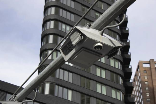 Recently installed toll traffic cameras hang above West End Ave. near 61st Street in Manhattan. (AP Photo/Ted Shaffrey, File)